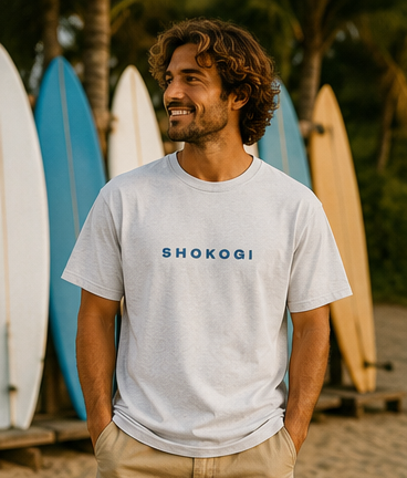 Man wearing an ash grey SHOKOGI t-shirt with the SHOKOGI logo on the chest at Playa Venao beach