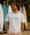 Man wearing an ash grey SHOKOGI t-shirt with the SHOKOGI logo on the chest at Playa Venao beach